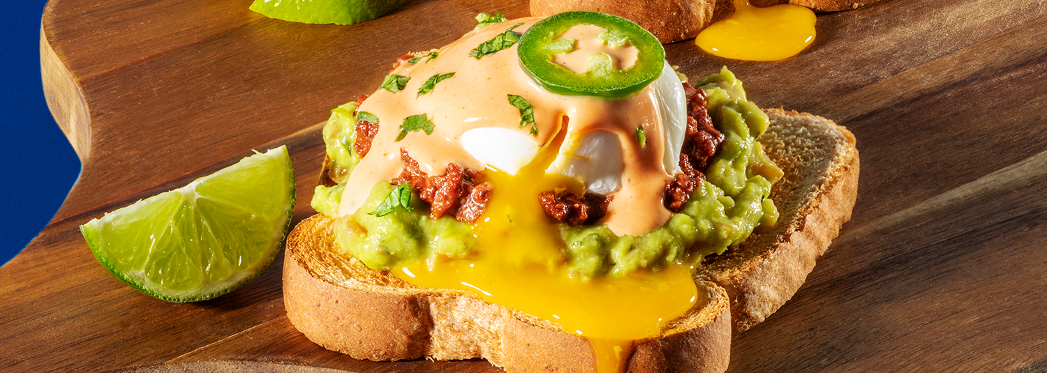 Eggs Benedict on Mrs Baird&#039;s Honey Wheat Bread with chorizo, guacamole, hollandaise sauce and eggs