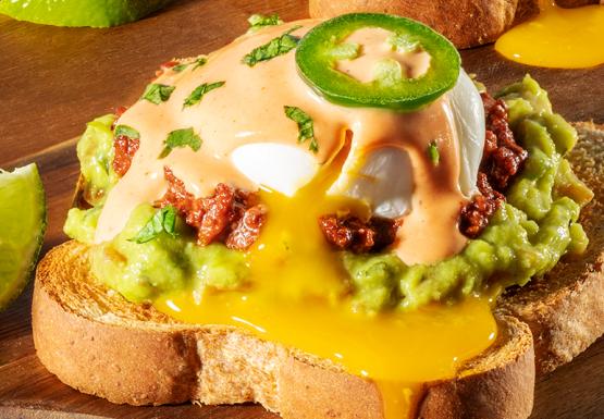 Eggs Benedict on Mrs Baird&#039;s Honey Wheat Bread with chorizo, guacamole, hollandaise sauce and eggs